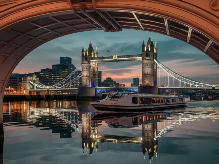 a boat on a river with a bridge and a city in the background