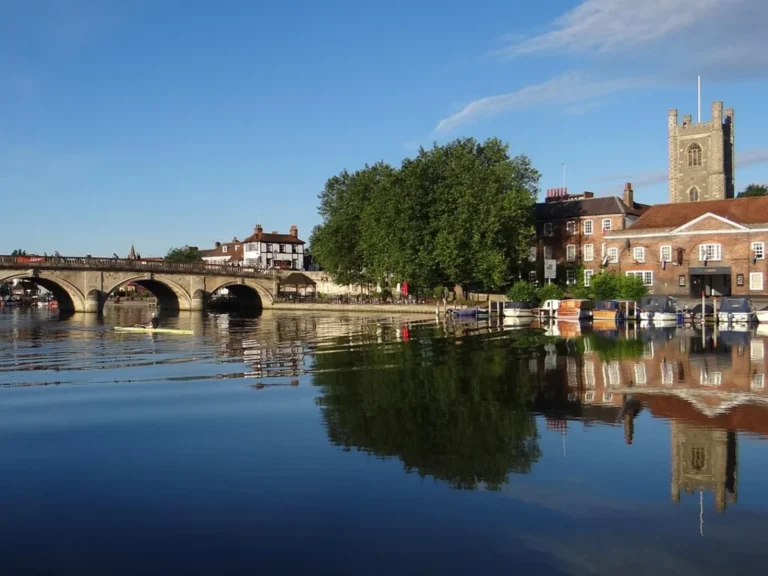 The five-arch Henley Bridge and the tower of St Mary's Church reflected in the Thames at Henley