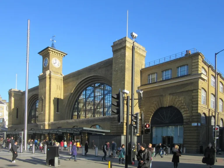 The brick frontage and clock tower of King's Cross station on Euston Road