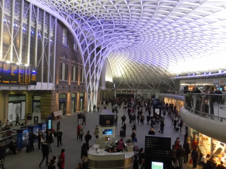 Travellers beneath the departure boards in the Western Concourse at King's Cross