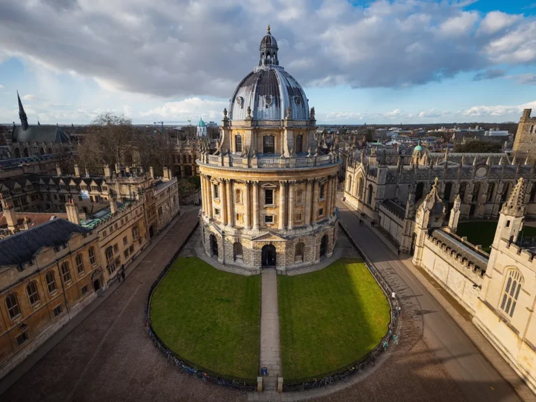 The domed Radcliffe Camera seen from above among the Oxford college roofs