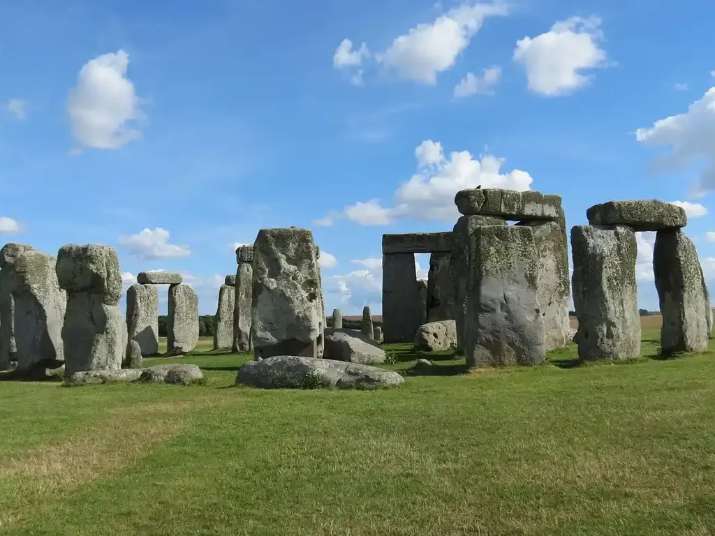 The standing stones of Stonehenge under a blue summer sky