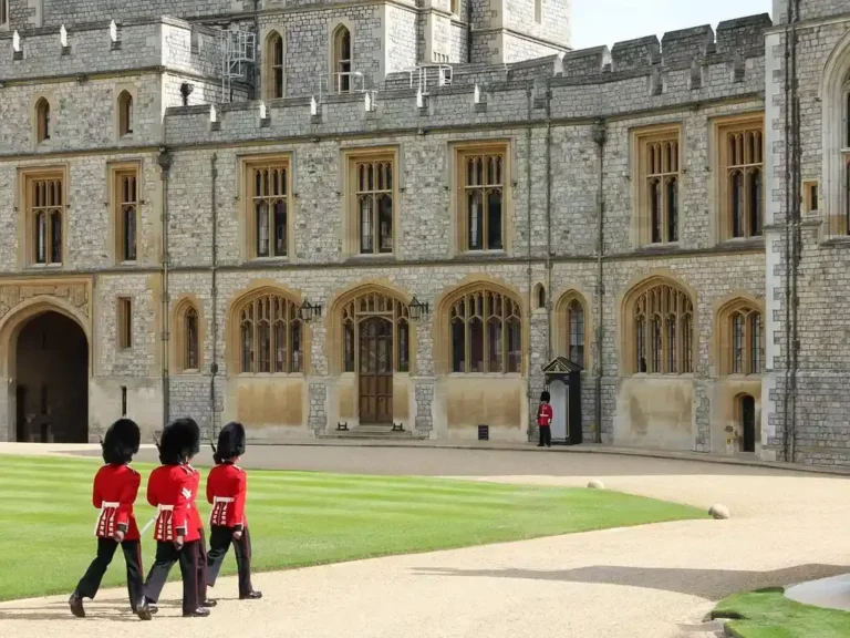 Guards in red tunics crossing the quadrangle of Windsor Castle