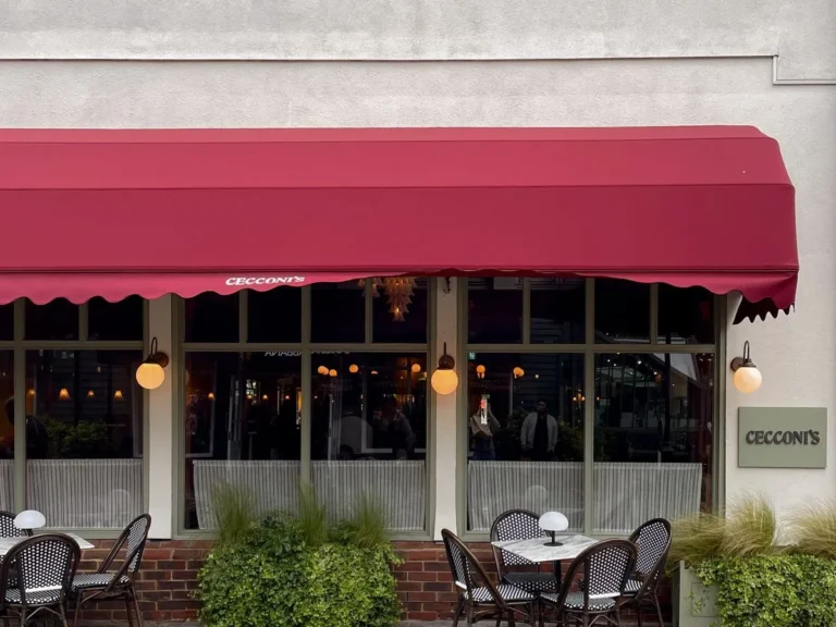Al fresco tables under the red awning of Cecconi's restaurant at Bicester Village