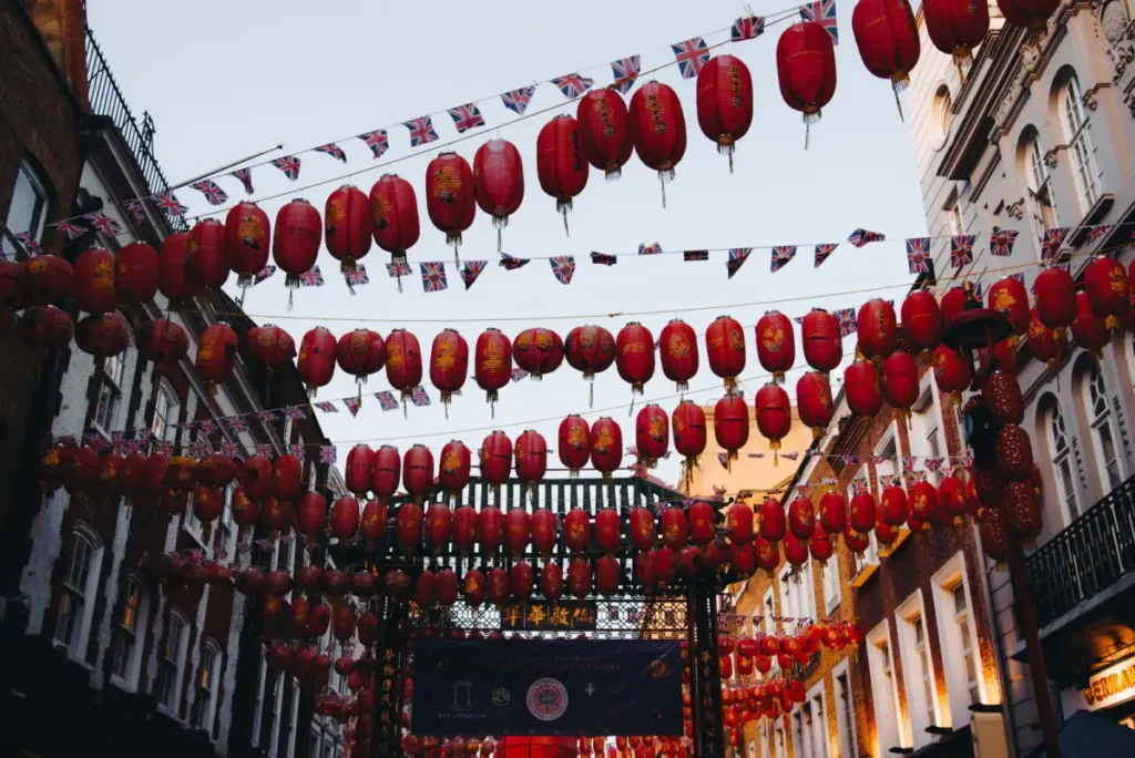 Red lanterns strung across a street in London Chinatown