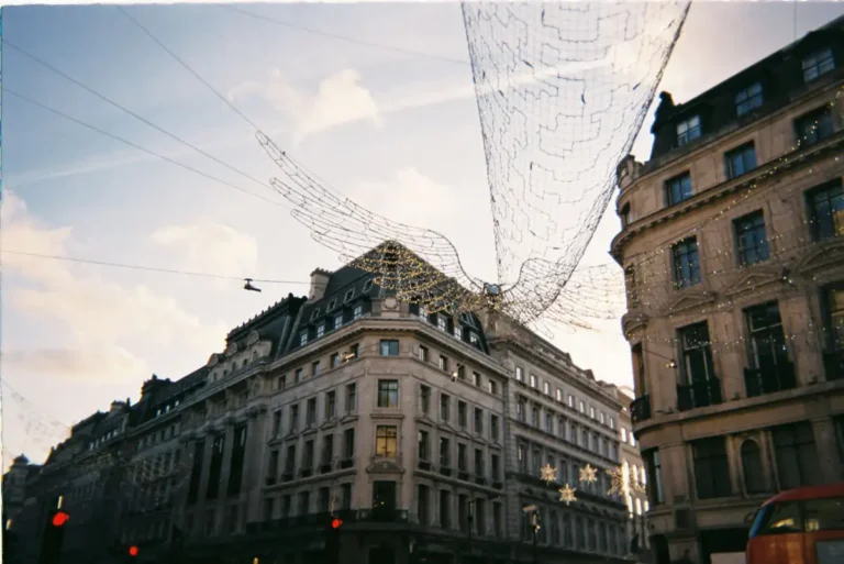 London buildings lit with festive lights at sunset in November