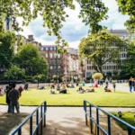Visitors relaxing in a sunny London park, typical weather in London in August