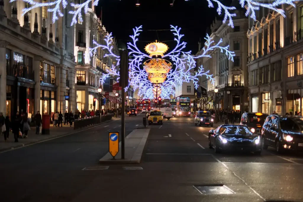 A London street decorated with festive Christmas lights at night