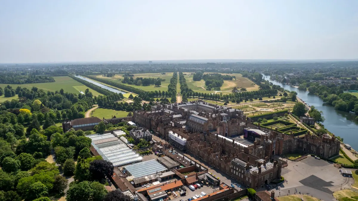 Hampton Court Palace from the air, its Tudor courtyards and gardens beside the River Thames