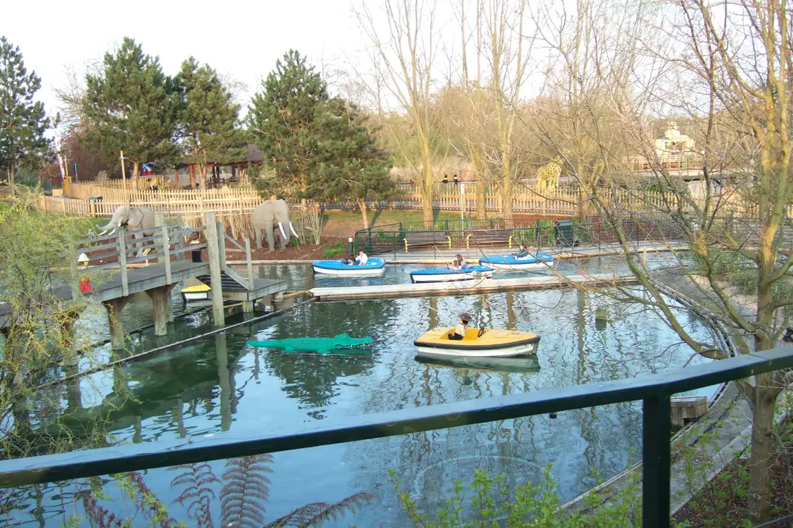 Small boats on the Boating School pond at Legoland Windsor, with Lego elephants on the bank and a Lego crocodile in the water