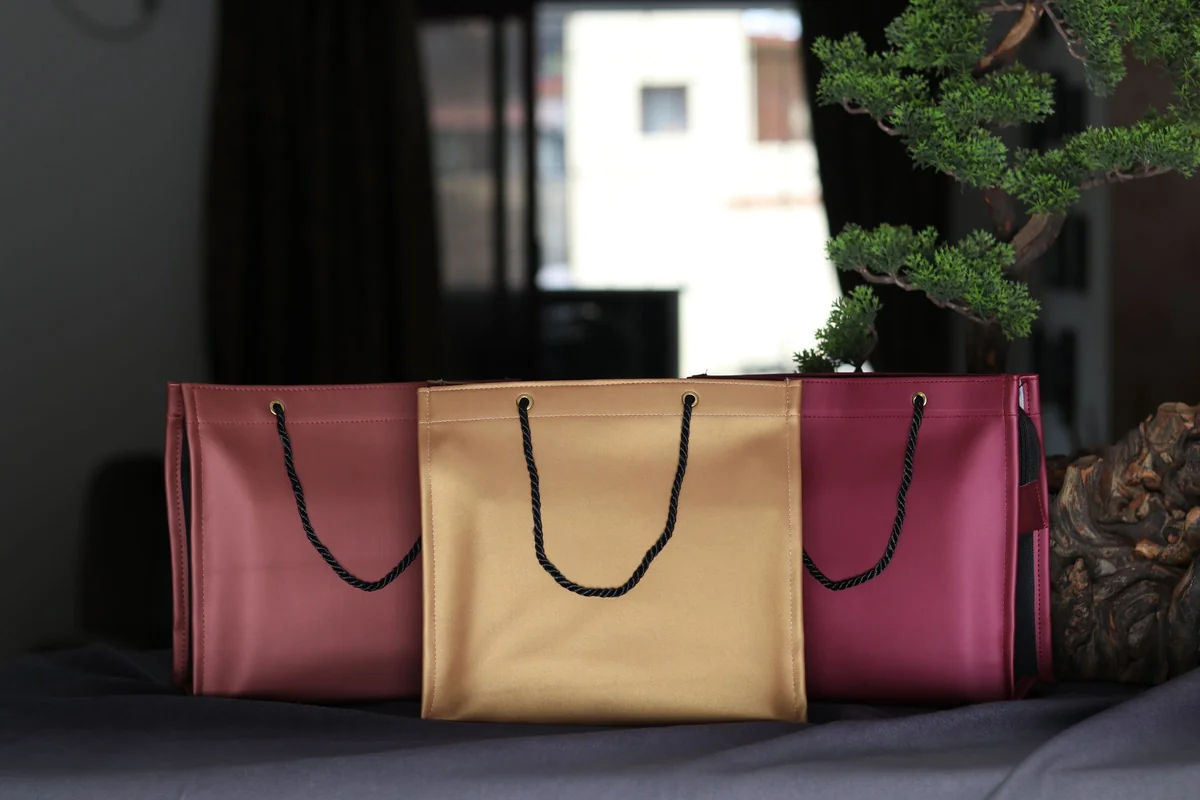 Luxury leather shopping bags, the kind that ride home in the boot on a chauffeur-driven London shopping day