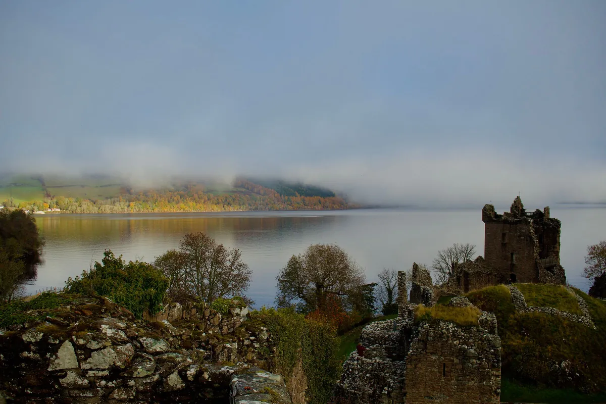Urquhart Castle ruins on the shore of Loch Ness in morning mist, day three of the Highlands itinerary