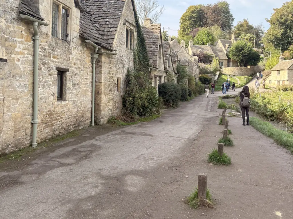 The stone cottages of Arlington Row in Bibury, the morning stop on day two, photographed on our tour in October 2026
